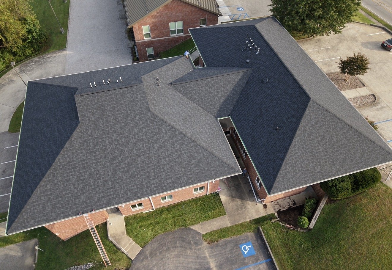 Commercial building with new roof and new 7-inch gutters by Hometown Exteriors and Roofing